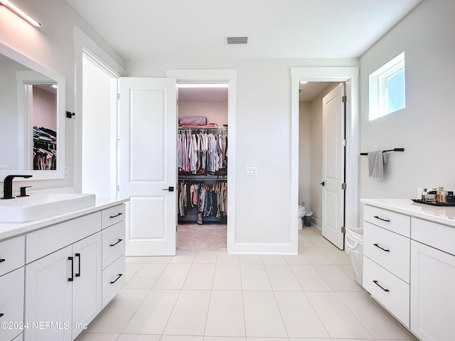 bathroom with tile patterned floors, vanity, and toilet