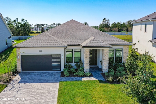 view of front facade featuring a front yard and a garage