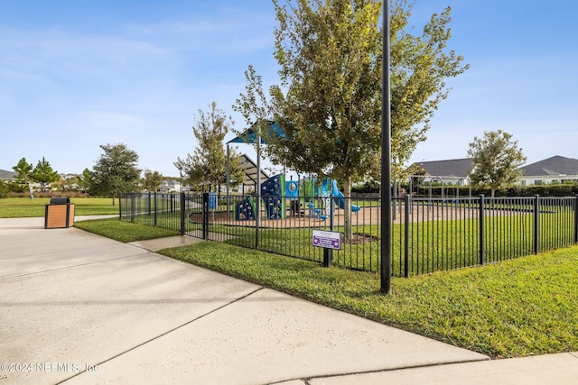 surrounding community featuring a playground and a yard