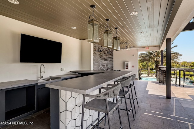 view of patio featuring ceiling fan and an outdoor wet bar