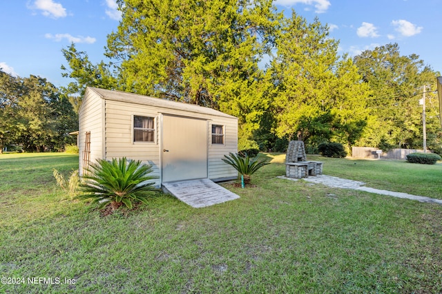 view of outbuilding with a yard