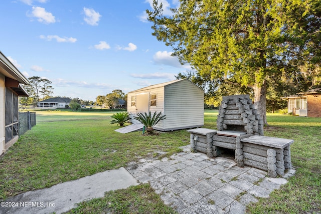 view of yard with a patio and a storage unit