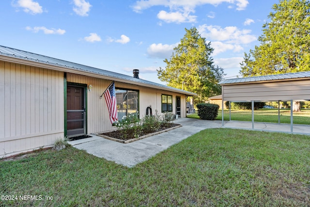 exterior space featuring a front lawn and a carport