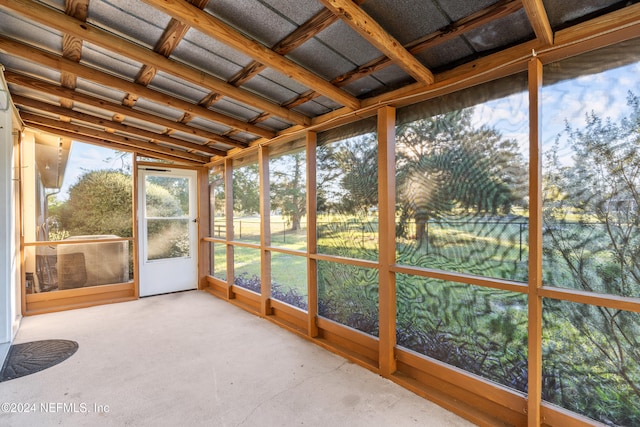 unfurnished sunroom featuring lofted ceiling