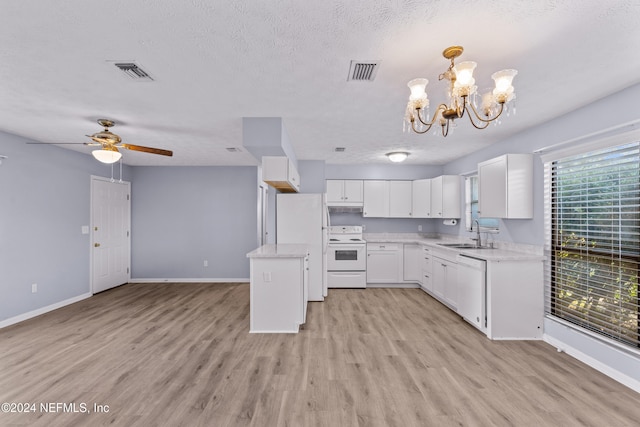 kitchen with white appliances, sink, pendant lighting, light hardwood / wood-style floors, and white cabinetry