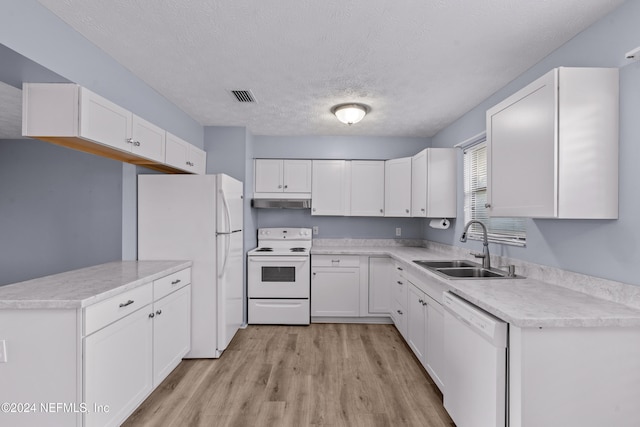 kitchen featuring white appliances, sink, a textured ceiling, light hardwood / wood-style floors, and white cabinetry