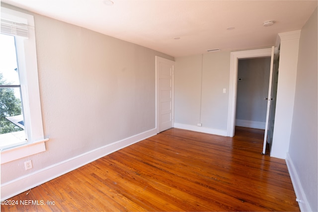 empty room with dark hardwood / wood-style floors