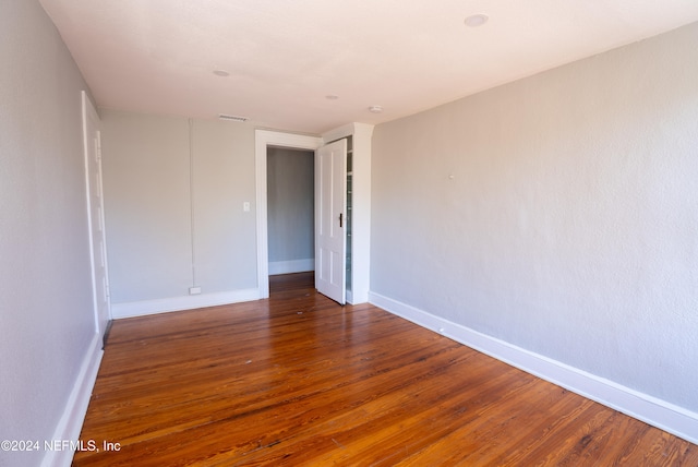 unfurnished room featuring dark hardwood / wood-style flooring