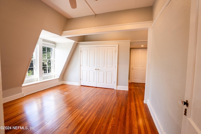 bonus room with dark wood-type flooring and ceiling fan