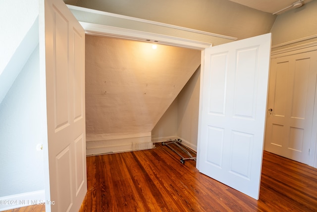 additional living space featuring hardwood / wood-style floors and lofted ceiling