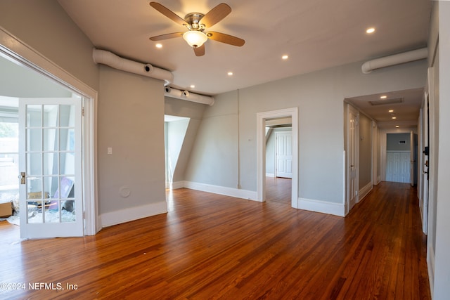 empty room with dark hardwood / wood-style flooring and ceiling fan