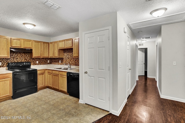 kitchen featuring light hardwood / wood-style flooring, sink, black appliances, a textured ceiling, and tasteful backsplash