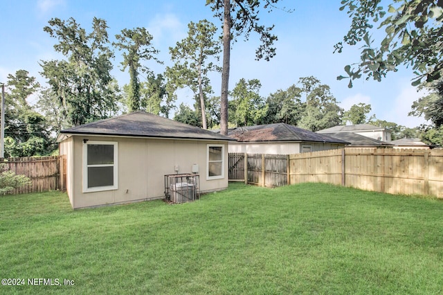 rear view of property featuring a lawn