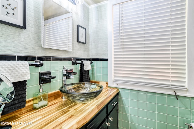 bathroom featuring vanity and tile walls