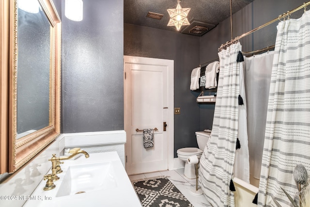 bathroom with toilet, tile patterned flooring, vanity, a textured ceiling, and walk in shower