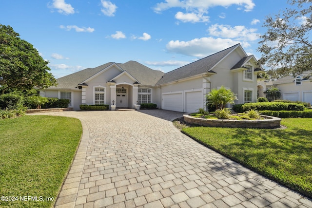 view of front of home featuring a garage and a front lawn