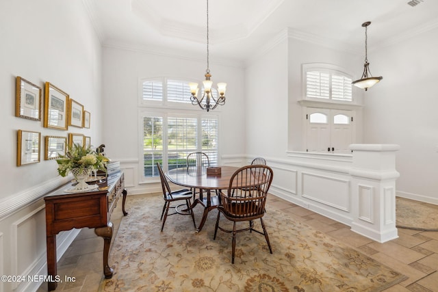 dining space featuring an inviting chandelier, crown molding, and plenty of natural light