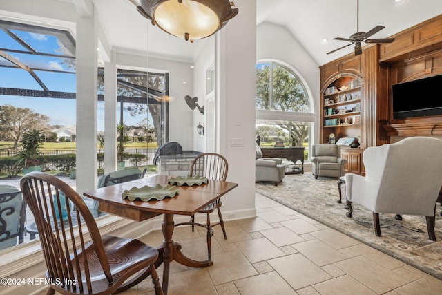 interior space featuring ceiling fan, high vaulted ceiling, and ornamental molding