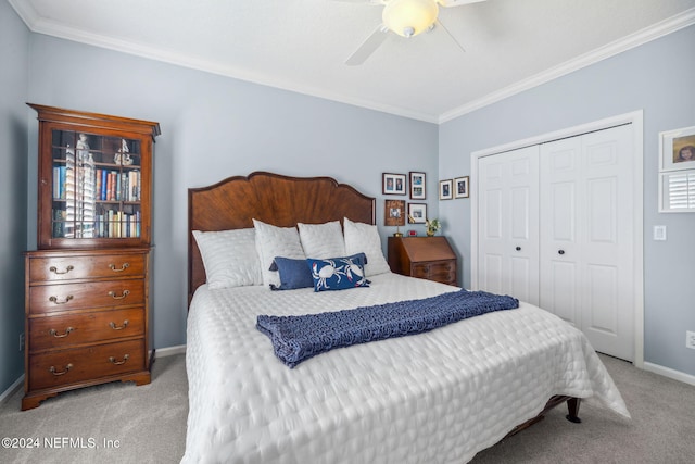 bedroom featuring ceiling fan, light carpet, a closet, and ornamental molding