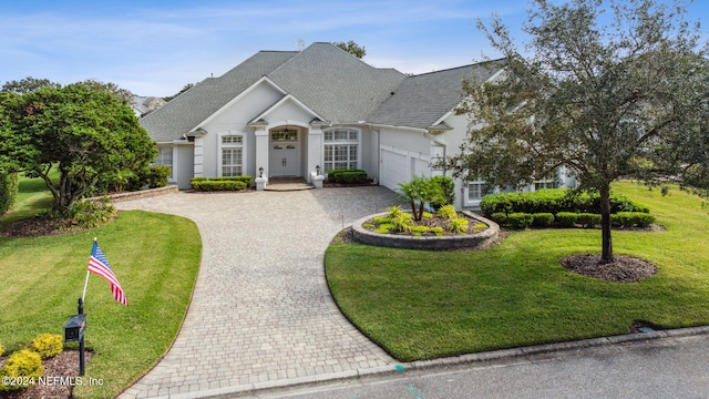 view of front of home with a garage and a front yard