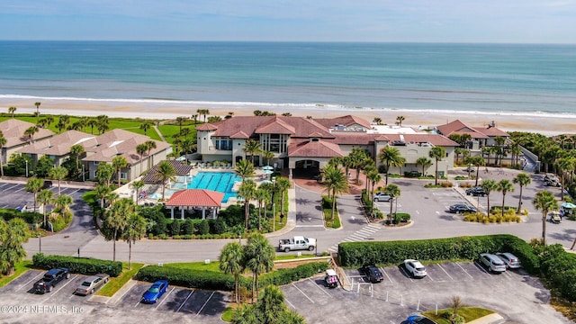 bird's eye view featuring a water view and a beach view