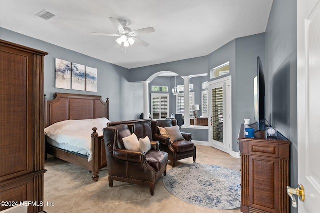 bedroom featuring ceiling fan, ornate columns, and light tile patterned floors