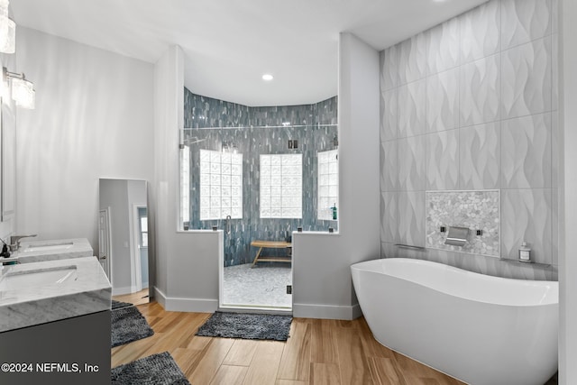 bathroom featuring separate shower and tub, vanity, tile walls, and hardwood / wood-style flooring