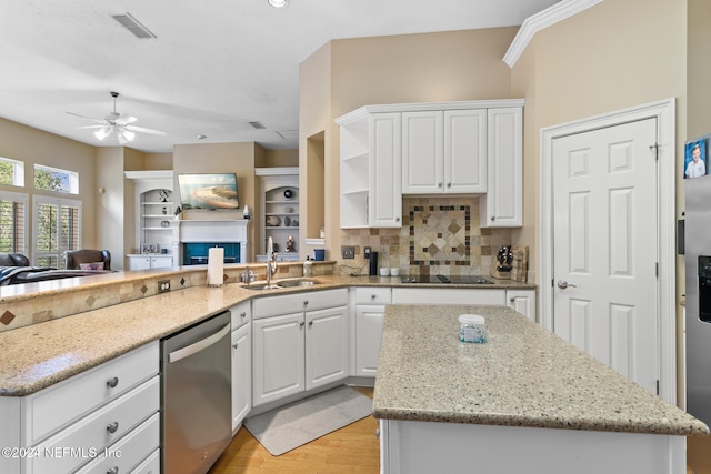 kitchen with backsplash, white cabinets, sink, light hardwood / wood-style flooring, and dishwasher