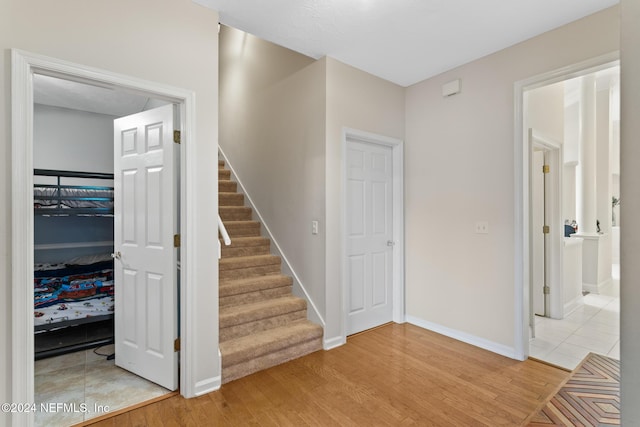 staircase featuring hardwood / wood-style floors