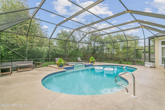 view of pool featuring a patio area, an in ground hot tub, and glass enclosure