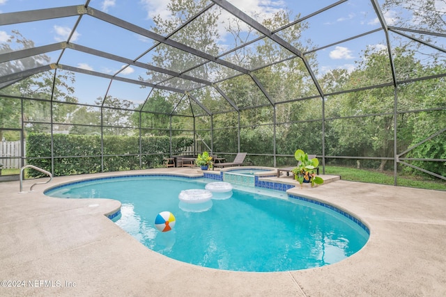 view of swimming pool with an in ground hot tub, a lanai, and a patio area