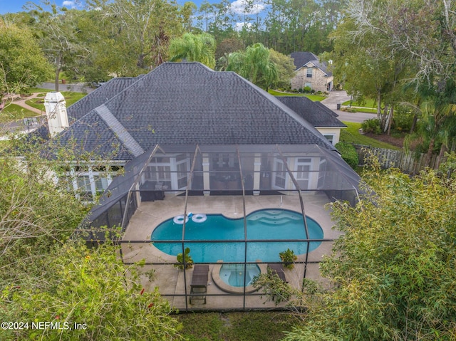 view of swimming pool with a lanai and a patio