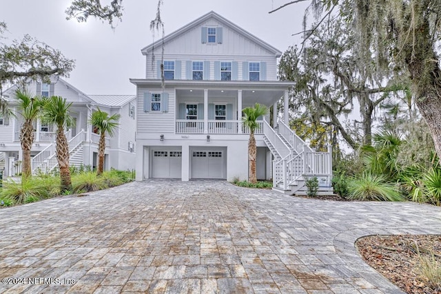 view of front of property featuring a porch and a garage