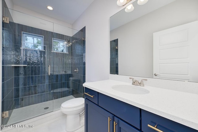 bathroom with tile patterned flooring, vanity, toilet, and a shower with shower door