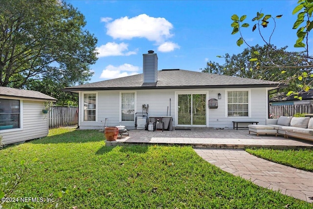 back of house with a patio area, outdoor lounge area, and a yard