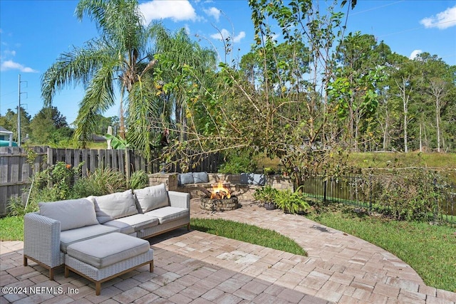 view of patio featuring an outdoor living space with a fire pit