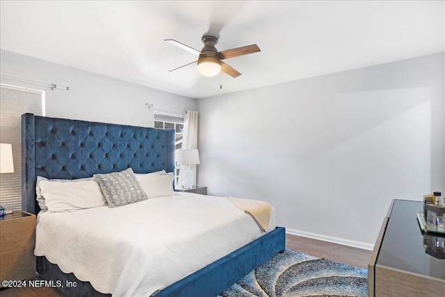 bedroom with ceiling fan and dark hardwood / wood-style flooring