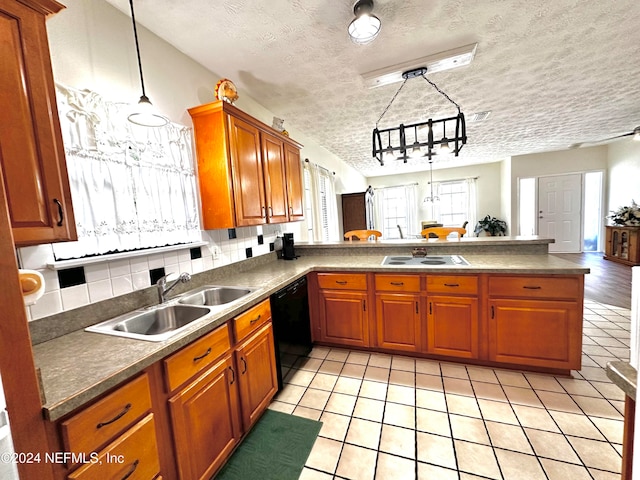 kitchen with dishwasher, decorative backsplash, kitchen peninsula, decorative light fixtures, and a textured ceiling