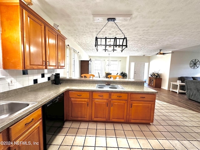 kitchen with black dishwasher, a textured ceiling, kitchen peninsula, ceiling fan, and light hardwood / wood-style flooring