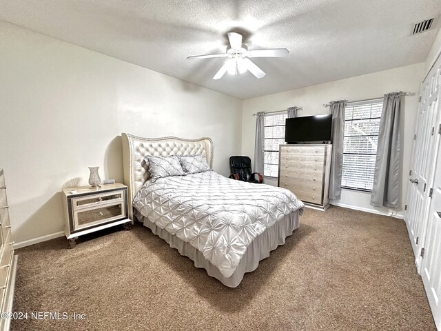 5609 County Road 352, Keystone Heights, FL 32656 - carpeted bedroom featuring a textured ceiling, baseboards, and a ceiling fan