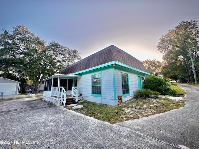 view of front facade with a sunroom