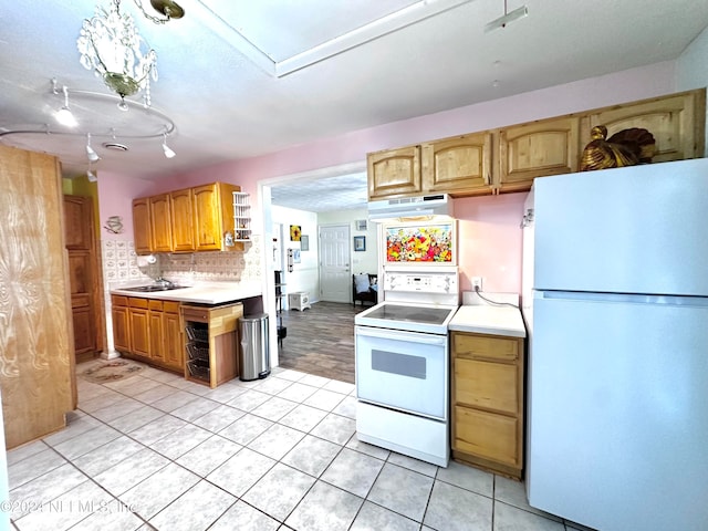 kitchen with decorative backsplash, hanging light fixtures, sink, light tile patterned floors, and white appliances