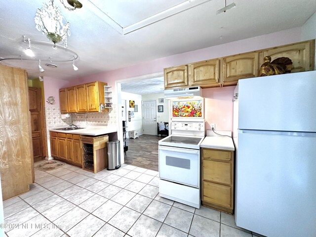 5609 County Road 352, Keystone Heights, FL 32656 - kitchen with white appliances, extractor fan, light tile patterned floors, light countertops, and decorative backsplash