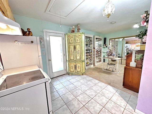 kitchen with light colored carpet and white stove