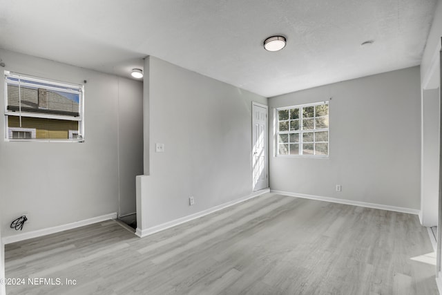 unfurnished room with light wood-type flooring