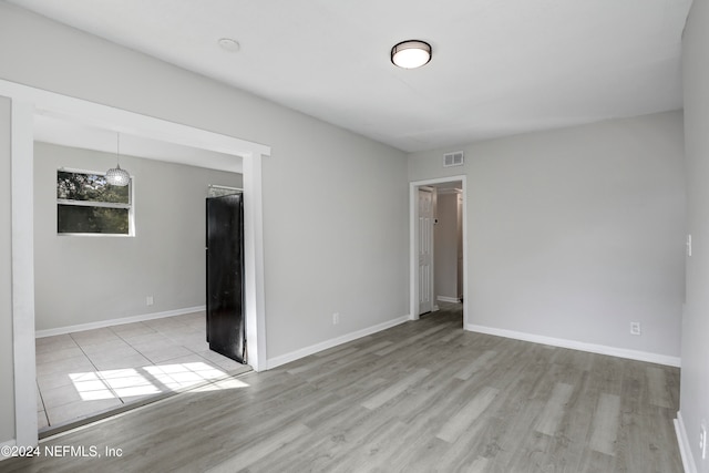 unfurnished room featuring light wood-type flooring