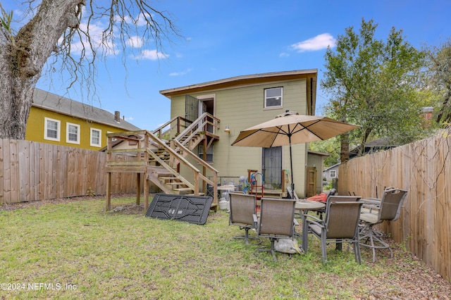 rear view of property with a patio and a lawn