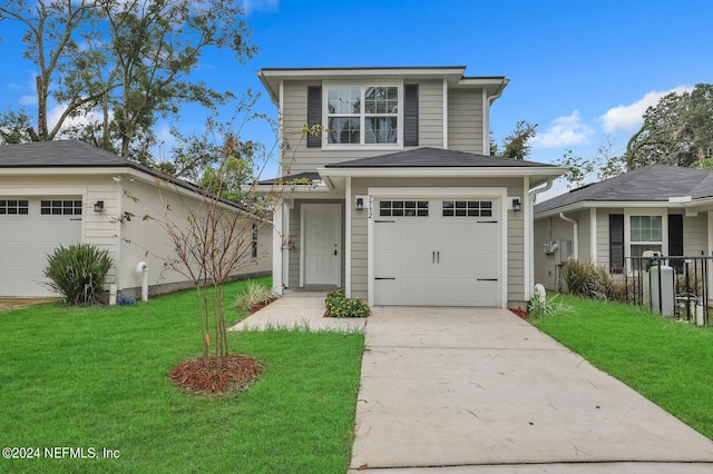 view of property featuring a front lawn and a garage