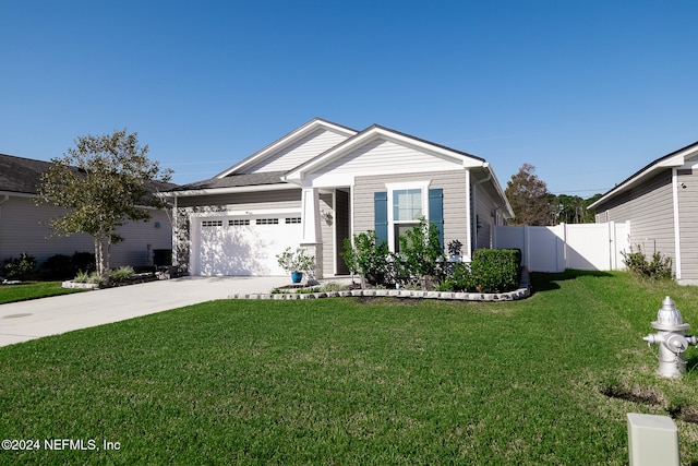 view of front of home with a garage and a front lawn