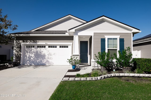 view of front facade featuring a garage and a front lawn